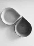 Modern decor drop-shaped black and white incense cone dishes on white background